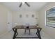 Brightly lit office area with ceiling fan, wooden desk and neutral decor at 9195 Bay Dr, Spring Hill, FL 34608