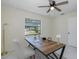 Bright, tiled office space featuring a desk, chair and a ceiling fan at 9195 Bay Dr, Spring Hill, FL 34608