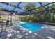 Enclosed pool with brick deck perfect for outdoor relaxation and entertaining at 9195 Bay Dr, Spring Hill, FL 34608