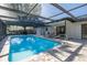 A sparkling pool and patio area provides a refreshing retreat at 9195 Bay Dr, Spring Hill, FL 34608