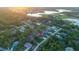 Aerial view of the property's location within a green neighborhood, showcasing proximity to a large body of water at 9201 Nightingale Rd, Weeki Wachee, FL 34613