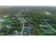 Aerial view of the property in a neighborhood surrounded by lush greenery and tranquil lakes at 9201 Nightingale Rd, Weeki Wachee, FL 34613
