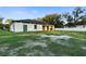 View of backyard featuring a covered patio and outdoor kitchen, ideal for enjoying the outdoors at 9201 Nightingale Rd, Weeki Wachee, FL 34613