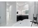 Modern bathroom featuring a freestanding tub, sleek black cabinetry, and illuminated mirrors at 9201 Nightingale Rd, Weeki Wachee, FL 34613
