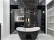 Elegant bathroom featuring a freestanding tub, marble-look tile, and a modern vanity at 9201 Nightingale Rd, Weeki Wachee, FL 34613
