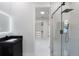 Contemporary bathroom featuring glass enclosed shower, a large mirror and black hardware at 9201 Nightingale Rd, Weeki Wachee, FL 34613