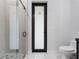 Modern bathroom with glass shower doors, minimalist fixtures, and a light gray color scheme at 9201 Nightingale Rd, Weeki Wachee, FL 34613