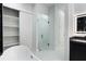 Bright bathroom showcasing a soaking tub, walk-in shower with glass doors, and ample storage at 9201 Nightingale Rd, Weeki Wachee, FL 34613