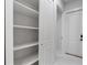 Spacious white closet with open shelving, drawers, and storage space at 9201 Nightingale Rd, Weeki Wachee, FL 34613
