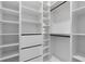 Custom walk-in closet features built-in shelves, drawers and ample hanging space at 9201 Nightingale Rd, Weeki Wachee, FL 34613
