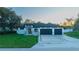 Modern home with a well-manicured lawn and a sleek, contemporary design at 9201 Nightingale Rd, Weeki Wachee, FL 34613