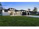 Elegant home featuring a modern design, manicured lawn, and a welcoming entrance at 9201 Nightingale Rd, Weeki Wachee, FL 34613