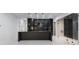 Modern kitchen boasting a center island with sleek black cabinetry and marble floors at 9201 Nightingale Rd, Weeki Wachee, FL 34613