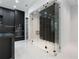 Modern kitchen showcases black cabinetry, stainless steel appliances, and glass enclosed wine cellar at 9201 Nightingale Rd, Weeki Wachee, FL 34613