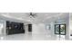 Open-concept living room with modern decor, featuring high ceilings and seamless flow to the kitchen at 9201 Nightingale Rd, Weeki Wachee, FL 34613