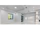 Bright living room featuring recessed lighting, tray ceilings, and a modern front door at 9201 Nightingale Rd, Weeki Wachee, FL 34613