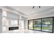 Bright living room featuring built-in shelving, a modern fireplace, and large sliding glass doors to the backyard at 9201 Nightingale Rd, Weeki Wachee, FL 34613