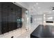 Bright, open-concept living room boasts a glass wine cellar, fireplace, and sleek finishes at 9201 Nightingale Rd, Weeki Wachee, FL 34613