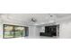Open-concept living room featuring modern design, sleek finishes, and a seamless flow to the kitchen at 9201 Nightingale Rd, Weeki Wachee, FL 34613