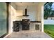 An outdoor kitchen provides a built-in grill, refrigerator, sink, and storage cabinets at 9201 Nightingale Rd, Weeki Wachee, FL 34613