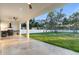 Tile floor stretches from the patio into a large yard with an outdoor kitchen, creating a seamless indoor/outdoor feel at 9201 Nightingale Rd, Weeki Wachee, FL 34613