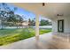 Covered patio with tile flooring overlooks a large, fenced backyard perfect for outdoor entertaining at 9201 Nightingale Rd, Weeki Wachee, FL 34613