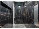 Modern shower with black and gold tile, rainfall showerhead, and built-in niche at 9201 Nightingale Rd, Weeki Wachee, FL 34613
