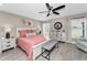 Cozy bedroom with a white bed frame, a gray bench, and plenty of natural light at 1009 Almondwood Dr, Trinity, FL 34655