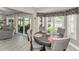 Cozy dining area with a round table, chair set, sliding glass doors, and stylish window treatments at 1009 Almondwood Dr, Trinity, FL 34655