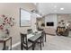 Stylish dining area with modern lighting, adjacent to a comfortable living space at 1009 Almondwood Dr, Trinity, FL 34655