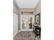 Bright foyer featuring a double front door with glass inserts, neutral walls, and a decorative console table at 1009 Almondwood Dr, Trinity, FL 34655