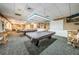 Well-lit recreation room featuring pool tables and cozy seating ideal for friendly competition at 1009 Almondwood Dr, Trinity, FL 34655