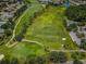 Aerial view of the pristine golf course with lush green fairways and scenic water hazards at 1009 Almondwood Dr, Trinity, FL 34655
