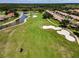 Aerial view showcases the golf course, water feature, and landscaping amongst homes in the community at 1009 Almondwood Dr, Trinity, FL 34655