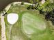 Overhead view of a well-maintained golf course with sand traps and a manicured green at 1009 Almondwood Dr, Trinity, FL 34655