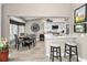 Well-designed kitchen and dining area featuring modern countertops, stainless steel appliances, and ample seating at 1009 Almondwood Dr, Trinity, FL 34655