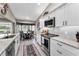 Contemporary kitchen featuring granite countertops, stainless steel appliances, and a cozy dining nook at 1009 Almondwood Dr, Trinity, FL 34655