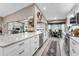Open-concept kitchen with white cabinets, stainless steel appliances, granite countertops, and a breakfast nook at 1009 Almondwood Dr, Trinity, FL 34655