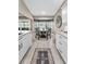 Bright kitchen area featuring a round dining table, white cabinets, and luxury vinyl plank flooring at 1009 Almondwood Dr, Trinity, FL 34655