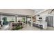 Spacious living area with seamless access to the outdoor patio and a modern kitchen at 1009 Almondwood Dr, Trinity, FL 34655