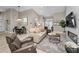 Inviting living room with neutral tones, comfortable seating, and a modern fireplace feature at 1009 Almondwood Dr, Trinity, FL 34655