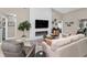 Cozy living room with a modern fireplace, comfortable seating, and sleek entertainment setup at 1009 Almondwood Dr, Trinity, FL 34655