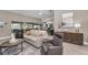 Open-concept living area showcasing stylish furniture and seamless flow to the kitchen and dining spaces at 1009 Almondwood Dr, Trinity, FL 34655