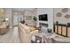 Cozy living room with modern fireplace feature, contemporary furnishings, and lots of natural light at 1009 Almondwood Dr, Trinity, FL 34655