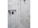 Luxurious walk-in shower with stylish tile work and convenient built-in niche at 1009 Almondwood Dr, Trinity, FL 34655