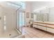 Bright bathroom boasting a glass-enclosed shower, toilet, and vanity with a sink, with pool views outside at 10285 Rosetti Ct, Spring Hill, FL 34608