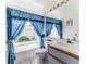Full bathroom offering a tub, toilet, vanity, and large window for natural light at 10285 Rosetti Ct, Spring Hill, FL 34608