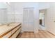 Well-lit bathroom featuring a spacious vanity with tiled floors and closet, plus doorway into another room at 10285 Rosetti Ct, Spring Hill, FL 34608