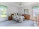 Bright bedroom featuring carpet flooring, light-colored walls, and two large windows at 10285 Rosetti Ct, Spring Hill, FL 34608