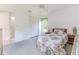 Bedroom with carpeted floors, neutral decor, and access to an en-suite bathroom at 10285 Rosetti Ct, Spring Hill, FL 34608